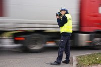Policjant wykonujący pomiar prędkości samochodów ciężarowych