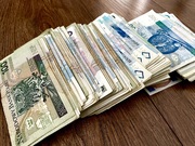 zdjęcie przedstawia blik banknotów rozłożony na blacie stolika